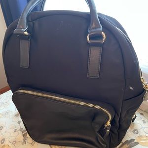 Lo & Son black nylon backpack with leather pocket and trim, lilac interior